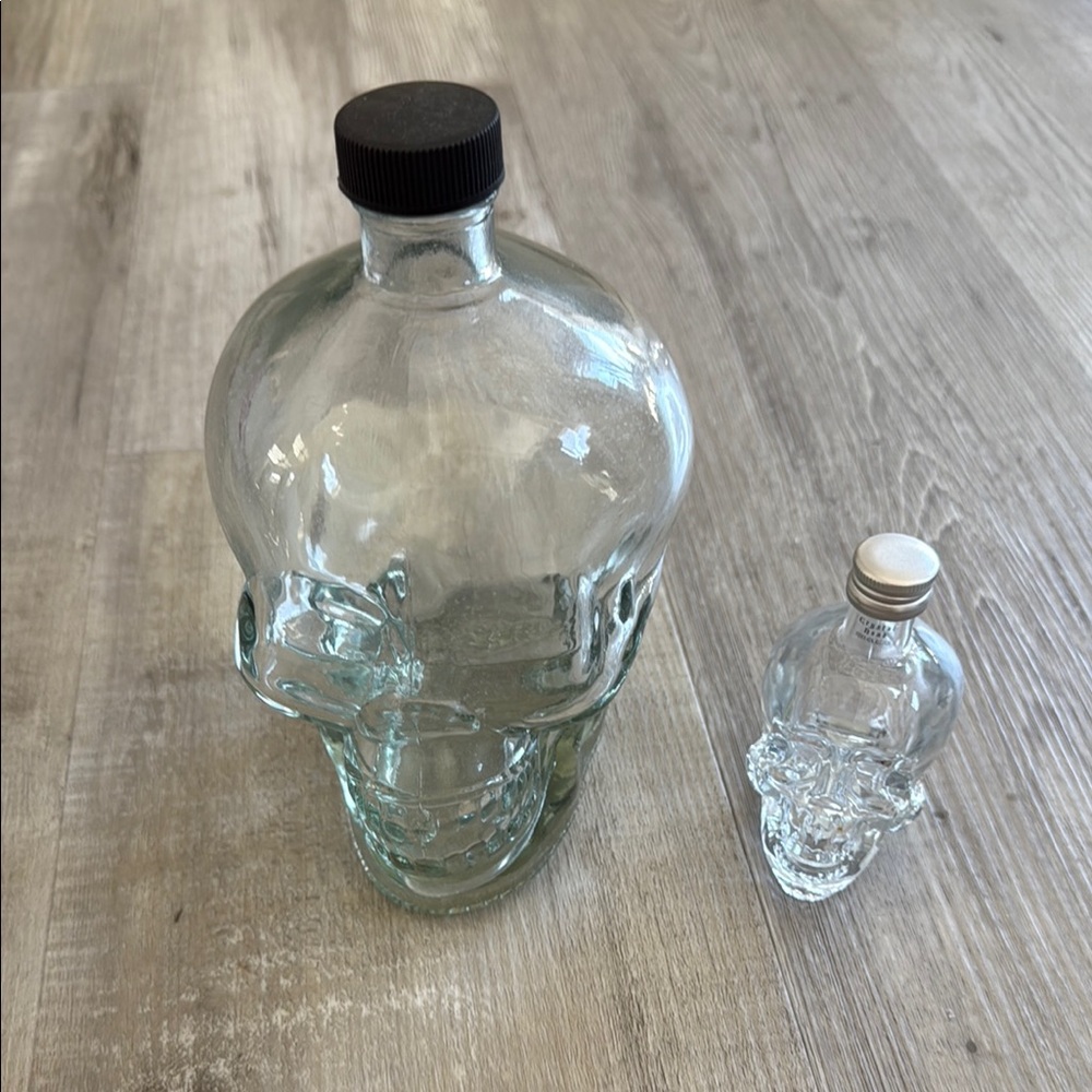 Set of two empty glass skull drink containers